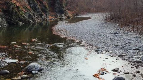 A small stream flowing in the mountains Stock Photos
