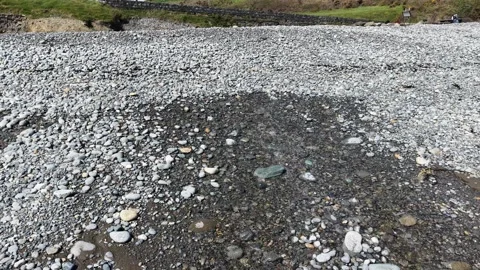 Small Stream Flowing Through Pebble Beach Stones 4K Stock Footage 333933411
