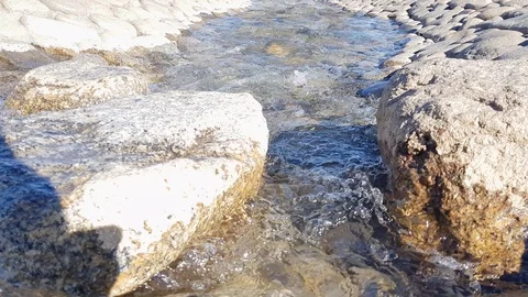 Small Stream Flowing Through Rocks slow Pan Stock Footage 107181904