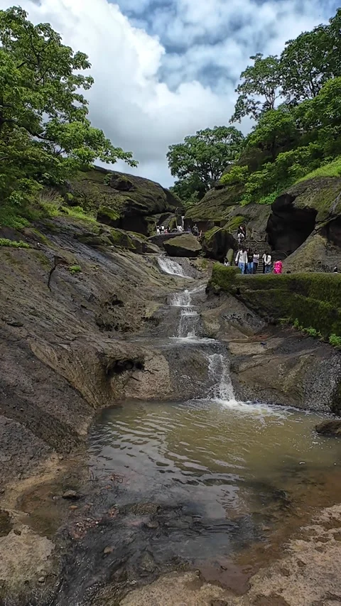Small Stream Flowing Through Rocky Terrain in Kanheri Caves, Maharashtra Stock Footage 287158383
