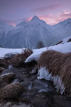 A small stream flows in the mountains Stock Photos