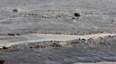 Small stream of hot water running throughout the mud at Geysir area, Iceland Stock Footage 33787920