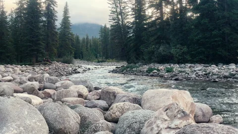 Small stream running through rocky bed in mountainous landscape, Canada. Stock Footage 288283667