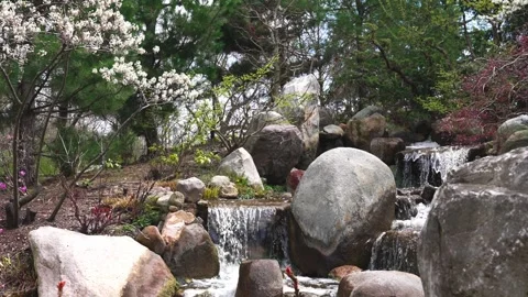 Small stream of water moving over rocks in outdoor setting 스톡 동영상 334092330
