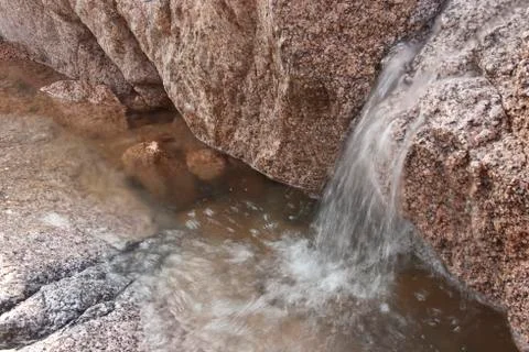A small stream of water running into a puddle. sharm el sheikh, Stock Photos