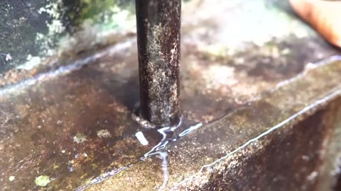Small stream of water from a rusty iron rod Video stock 220239802