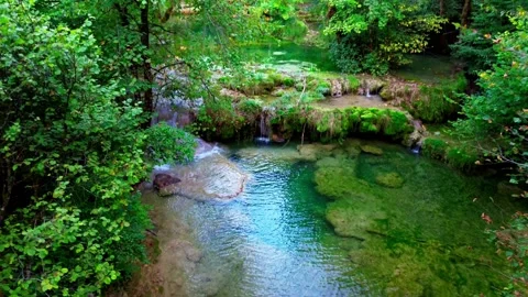 Small stream with waterfall and moss-covered rocks in france Stock Footage 316181625