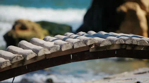 A small stream, which flows into the sea.people pass through the bridge Stock Footage 22680681