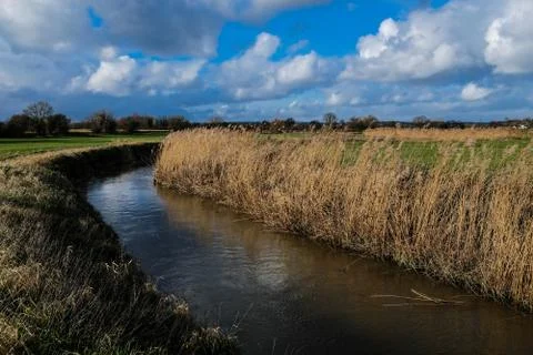 A small stream winds its way through the English countryside Stock Photos
