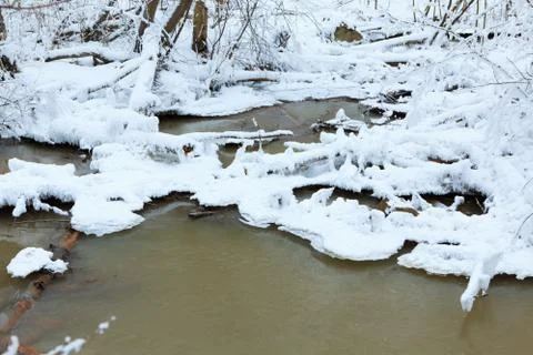 Small stream in winter forest Stock Photos