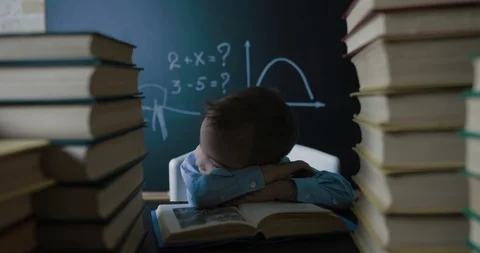 A small student sleeps on a school table Stock Footage 86508840