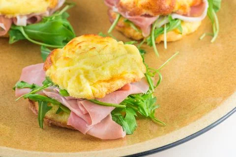 Small stuffed omelette with rocket salad, speck - cooked ham Stock Photos