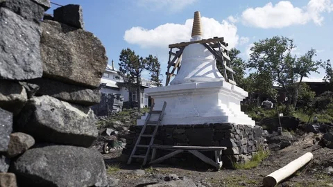 Small stupa in buddhist temple backyard Blue sky and tall trees on background Stock-Footage 96158993