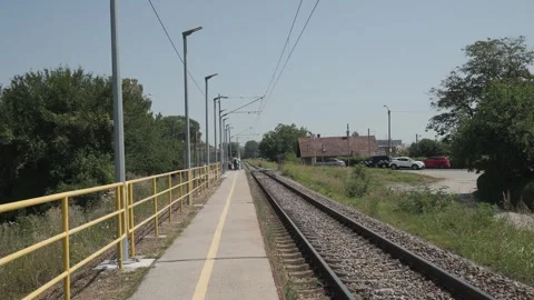 A small suburban rail platform at Remetinec railway station stretches alongside Stock Footage 341164327