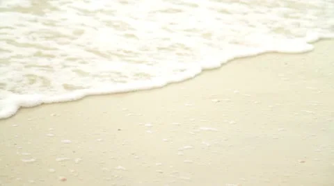 Small Sudsy Waves Break on Beach Видео 18073086