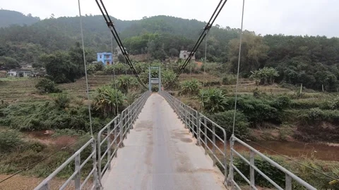 A small suspension bridge in a remote mountainous area in the North of Vietnam Stock Footage 172342934