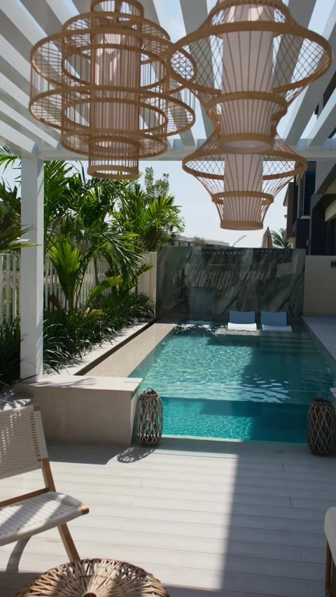 Small swimming pool with canopy and sofa in the backyard of a private villa in Stock Footage 280307523