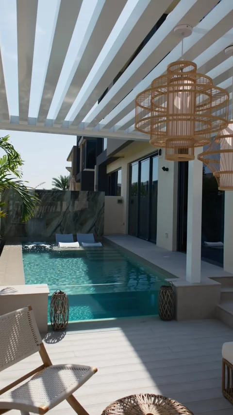 Small swimming pool with canopy and sofa in the backyard of a private villa in Stock Footage 308353112