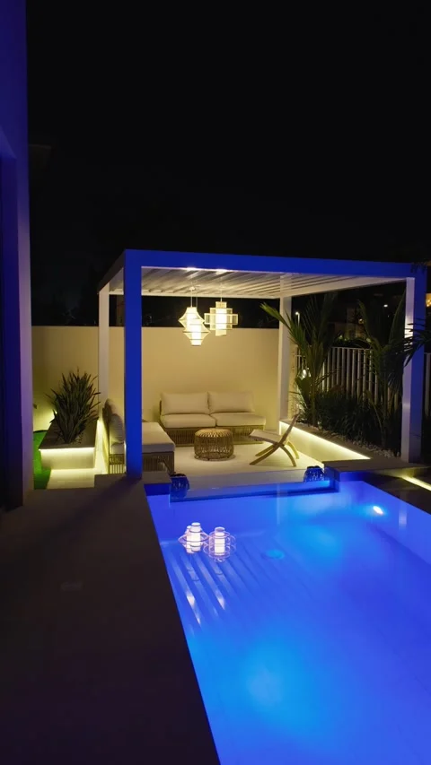 Small swimming pool with canopy and sofa in the backyard of a private villa in Stock Footage 308353499