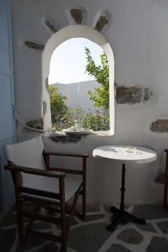 A small table and a chair on a small balcony in Amorgos, it's just what you n Stock Photos