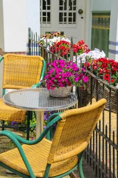 Small table and two chairs on a  fenced terrace near the building. Zandvoort, Stock Photos