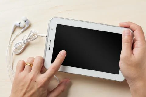 Small tablet pc with in ear headset Stock Photos