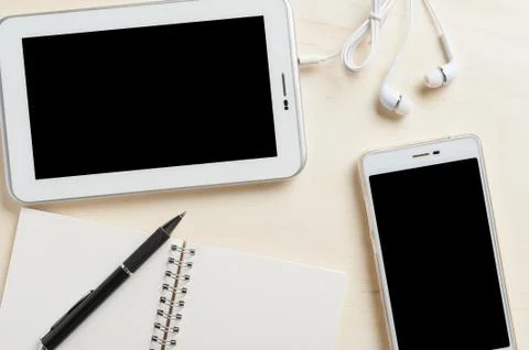 Small tablet pc with in ear headset Stock Photos