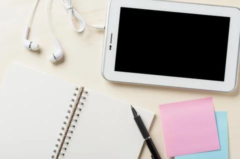 Small tablet pc with in ear headset Stock Photos