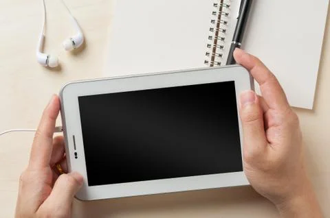 Small tablet pc with in ear headset Stock Photos