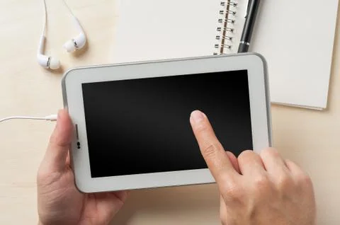 Small tablet pc with in ear headset Stock Photos