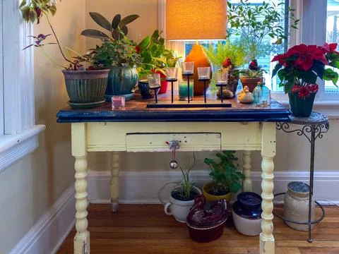 Small tabletop desk decorated for the holidays poinsettia Stock Photos