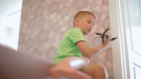 Small, talented boy playing with a toy airplane Stock Footage 40331480