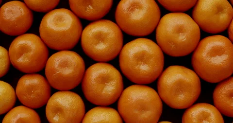 Small tangerines background top view. Table spin. Stock Footage 296499970