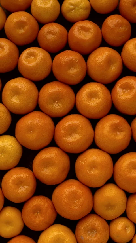 Small tangerines background top view. Table spin. Vertical video. Stock Footage 296500477