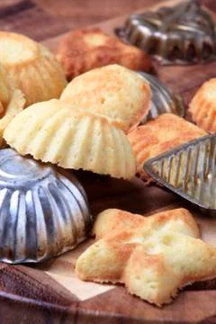 Small tart shells and baking pans on a cutting board Stock Photos