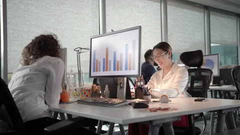 Small Team of Young Professionals Having a Conversation While Working Late Stock Footage 137520529