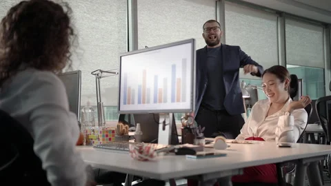 Small Team of Young Professionals Joking Around While Working Late Stock Footage 137518984