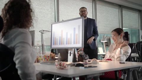 Small Team of Young Professionals Joking Around While Working Late Stock Footage 138444226