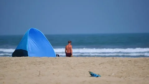 Small tent on the sandy ocean shore Stock Footage 264093045