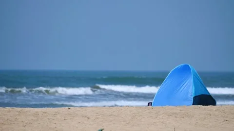 Small tent on the sandy ocean shore Stock Footage 264093163