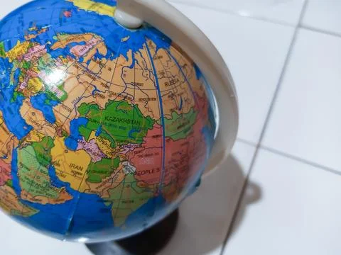 Small terrestrial globe with white background. Close Up Plastic Globe with .. Stock Photos