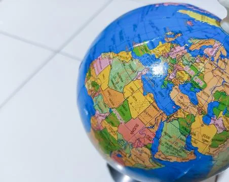 Small terrestrial globe with white background. Close Up Plastic Globe with .. Stock Photos