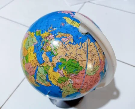 Small terrestrial globe with white background. Close Up Plastic Globe with .. Stock Photos