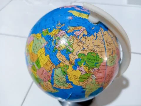 Small terrestrial globe with white background. Close Up Plastic Globe with .. Stock Photos