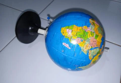 Small terrestrial globe with white background. Close Up Plastic Globe with .. Stock Photos