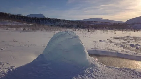Small thermal spring with hot water against melting ice Stock Footage 112531588