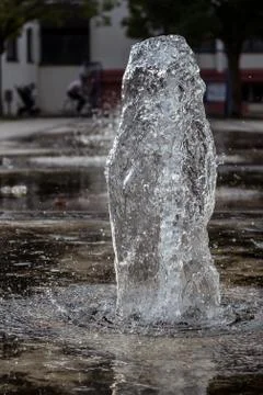 Small thick water jet of a park fountain, close up. Fotos de archivo