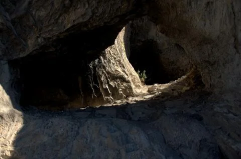 Small through cave in the mountain range. Altai, Siberia, Russia. Landscape. Stock Photos