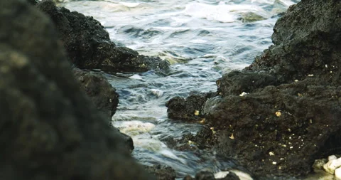 Small tide pool with ocean waves between volcanic rock in Hawaii Stock Footage 330754212