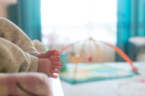 The small tiny cute feet of the infant. Blurred light background Stock Photos